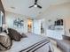 This main bedroom features vaulted ceilings, a ceiling fan, and ensuite bathroom access at 938 Larkspur Ln, Louisville, CO 80027