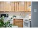 Close-up of the kitchen area featuring light cabinets and modern appliances at 1390 N Emerson St # 106, Denver, CO 80218
