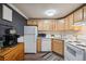 Well-lit kitchen area with natural wood cabinets and contemporary appliances at 1390 N Emerson St # 106, Denver, CO 80218