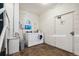 This is a shared laundry room with modern machines and tiled floor at 1390 N Emerson St # 106, Denver, CO 80218