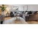 Inviting living room featuring a comfortable, oversized sectional sofa and bright natural light at 1390 N Emerson St # 106, Denver, CO 80218