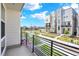 Balcony with wrought iron railing, offering views of the community and street at 11205 W 53Rd Ln, Arvada, CO 80002