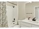 Bright bathroom featuring a shower-tub combo with stylish shower curtain and bronze hardware at 11205 W 53Rd Ln, Arvada, CO 80002