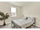 Bedroom with neutral color scheme, decorative plant, and comfy full-sized bed at 11205 W 53Rd Ln, Arvada, CO 80002