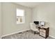 Office with a large window providing lots of light, a neutral carpet and desk with computers at 11205 W 53Rd Ln, Arvada, CO 80002