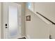 Bright entryway with frosted front door, coat hooks, and staircase at 11205 W 53Rd Ln, Arvada, CO 80002