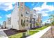 Row of modern townhomes with stone and siding exterior accents and small balconies at 11205 W 53Rd Ln, Arvada, CO 80002