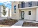 Modern townhome entrance with stone accent wall and small landscaping bed at 11205 W 53Rd Ln, Arvada, CO 80002