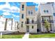 Modern three-story townhome with stone accent tower and small balcony under a cloudy sky at 11205 W 53Rd Ln, Arvada, CO 80002