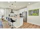Modern kitchen with white cabinets, stainless steel appliances, and bar stool seating at 11205 W 53Rd Ln, Arvada, CO 80002