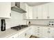 Close-up of modern kitchen area showcasing stainless steel vent hood and gas cooktop at 11205 W 53Rd Ln, Arvada, CO 80002