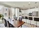 Open kitchen and dining area with lots of natural light, stainless steel appliances, and seating for six at 11205 W 53Rd Ln, Arvada, CO 80002
