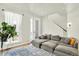 Spacious living room with sectional sofa, lots of light, and a modern plant stand at 11205 W 53Rd Ln, Arvada, CO 80002