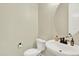 Cozy half bath with a modern sink, decorative mirror, and neutral wall color at 11205 W 53Rd Ln, Arvada, CO 80002