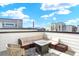 Rooftop patio featuring a comfortable sectional sofa and stylish area rug at 11205 W 53Rd Ln, Arvada, CO 80002