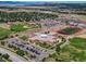 Aerial view of the school showing baseball field, football field, parking lots, and greenery at 1280 Gentle Rain Dr, Castle Rock, CO 80109
