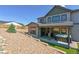 Landscaped backyard with a covered patio featuring a hot tub and tiered landscape design at 1280 Gentle Rain Dr, Castle Rock, CO 80109