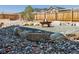Landscaped backyard with a cozy stone fire pit and a charming wooden fence at 1280 Gentle Rain Dr, Castle Rock, CO 80109
