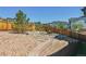 Seating area and firepit located in a landscaped backyard with a wooden fence at 1280 Gentle Rain Dr, Castle Rock, CO 80109