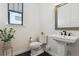 Minimalist powder room with pedestal sink and decorative plant at 1280 Gentle Rain Dr, Castle Rock, CO 80109