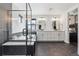 Modern bathroom featuring black marble accents, a soaking tub, a glass-enclosed shower, and dual vanities at 1280 Gentle Rain Dr, Castle Rock, CO 80109
