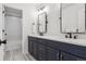Stylish bathroom with navy blue cabinets, quartz countertops, dual sinks, and modern fixtures at 1280 Gentle Rain Dr, Castle Rock, CO 80109