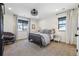 Cozy bedroom with a queen bed, neutral carpet, recessed lights, and natural light from the window at 1280 Gentle Rain Dr, Castle Rock, CO 80109