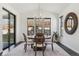 Bright dining room with modern chandelier, large windows, and dark floors at 1280 Gentle Rain Dr, Castle Rock, CO 80109