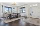 Bright dining room featuring a modern light fixture, rug, and an adjacent door at 1280 Gentle Rain Dr, Castle Rock, CO 80109