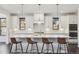 Modern kitchen with white cabinets, stainless steel appliances, and a large island with bar seating at 1280 Gentle Rain Dr, Castle Rock, CO 80109
