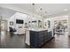 Open concept kitchen with island, modern appliances, and view into a living area at 1280 Gentle Rain Dr, Castle Rock, CO 80109