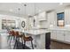 Modern kitchen with white cabinets, a large island, barstool seating, and pendant lighting at 1280 Gentle Rain Dr, Castle Rock, CO 80109
