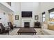 Light-filled living room boasts a fireplace, plush seating, and hardwood floors at 1280 Gentle Rain Dr, Castle Rock, CO 80109