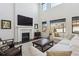 Bright living room with fireplace, large windows, and cozy sectional sofa at 1280 Gentle Rain Dr, Castle Rock, CO 80109