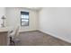 Bright room with plush carpet, a desk, and a large window with views of the surrounding neighborhood at 1280 Gentle Rain Dr, Castle Rock, CO 80109
