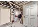 Unfinished basement with exposed pipes and utilities, offering potential for customization at 125 E 11Th Ave # 2, Denver, CO 80203