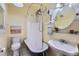 Cozy bathroom with claw foot tub and shower, pedestal sink, and vintage mirror at 125 E 11Th Ave # 2, Denver, CO 80203