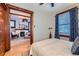 Bedroom with hardwood floors, and view to living room with fireplace at 125 E 11Th Ave # 2, Denver, CO 80203