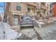 Brick two-story home with front door and car parked in driveway at 125 E 11Th Ave # 2, Denver, CO 80203