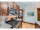 Corner view of kitchen with stainless steel appliances, range, and wood cabinetry at 125 E 11Th Ave # 2, Denver, CO 80203