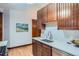 Kitchen area featuring stainless steel sink, stainless steel dishwasher, and wood cabinets at 125 E 11Th Ave # 2, Denver, CO 80203