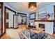 Comfortable living room with hardwood floors, fireplace, stylish rug, and seamless access to the office space and kitchen at 125 E 11Th Ave # 2, Denver, CO 80203