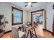 Bright home office with a modern desk, large window, and view into the living room at 125 E 11Th Ave # 2, Denver, CO 80203