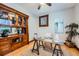 Home office features a glass desk, natural lighting, vintage hutch, and hardwood flooring for a functional workspace at 125 E 11Th Ave # 2, Denver, CO 80203
