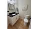Small bathroom boasts a modern sink, white cabinet and dark countertop at 5352 Brookside Dr, Broomfield, CO 80020