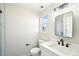 Modern bathroom features white cabinets, quartz countertops, and black hardware accents at 5352 Brookside Dr, Broomfield, CO 80020
