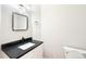 Modern powder room featuring marble counters, a gold faucet, and contemporary lighting at 5352 Brookside Dr, Broomfield, CO 80020