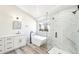 Sleek bathroom boasts a soaking tub, glass enclosed shower, marble accents, and modern fixtures at 5352 Brookside Dr, Broomfield, CO 80020