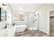 Sleek bathroom boasts a soaking tub, glass enclosed shower, marble accents, and modern fixtures at 5352 Brookside Dr, Broomfield, CO 80020