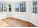 Bright bedroom featuring large windows, beautiful wood floors and white walls at 5352 Brookside Dr, Broomfield, CO 80020